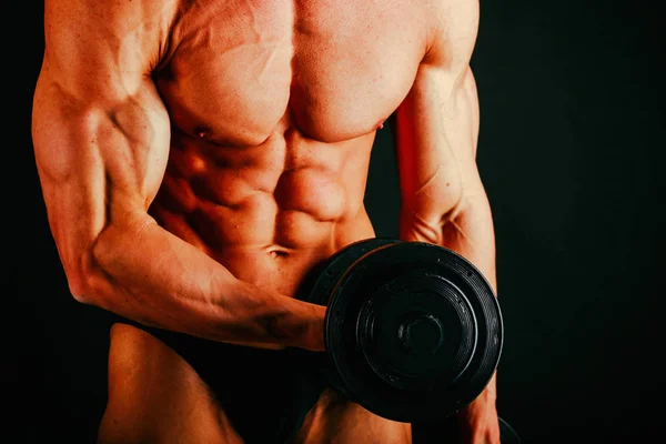 Men's muscles on a black background — Stock Photo, Image