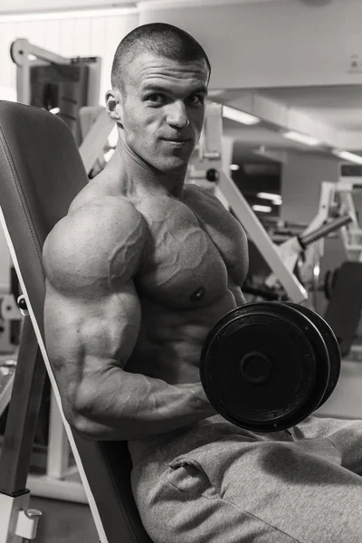 Uomo con un manubrio nel fitness club — Foto Stock