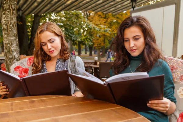 Girls in the cafe on the street