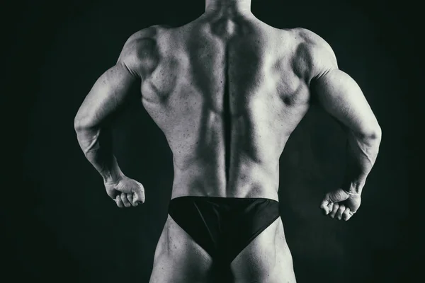 Bodybuilder showing his back and biceps muscles, personal fitnes — Stock Photo, Image