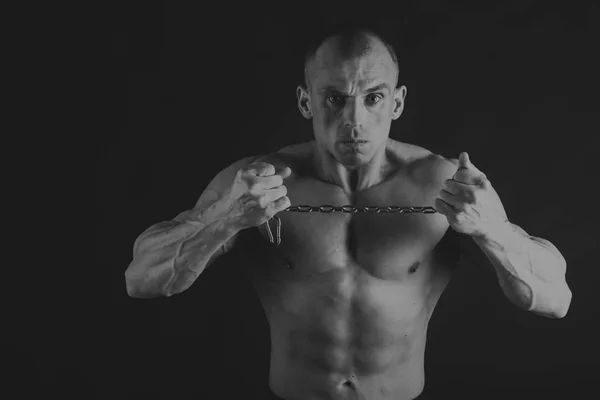 Fisiculturista posando em diferentes poses demonstrando seus músculos. Falha num fundo escuro. Homem mostrando músculos se esforçando. Bonito atleta corpo muscular . — Fotografia de Stock