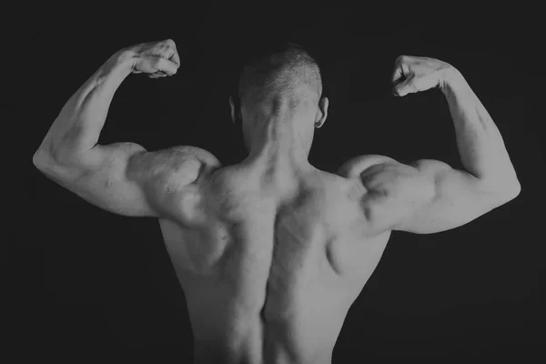 Handsome power athletic man in training pumping up muscles with — Stock Photo, Image