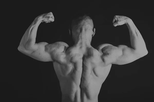 Handsome power athletic man in training pumping up muscles with — Stock Photo, Image