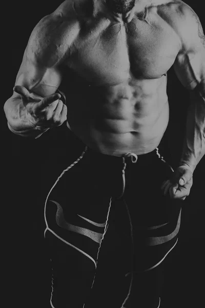 Male power fitness on a black background — Stock Photo, Image