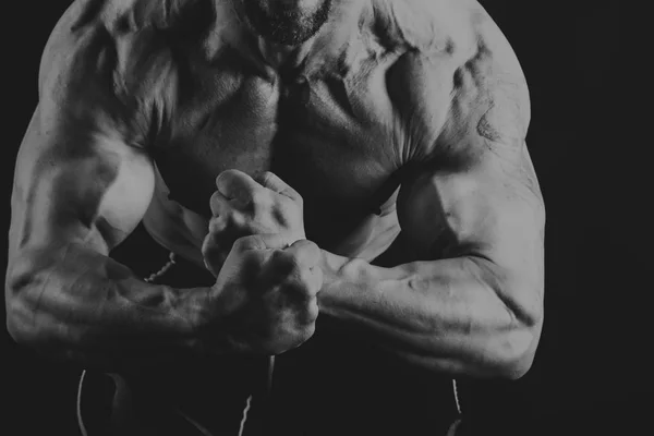 Male power fitness on a black background — Stock Photo, Image