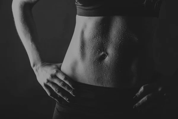 Female fitness on a black background — Stock Photo, Image