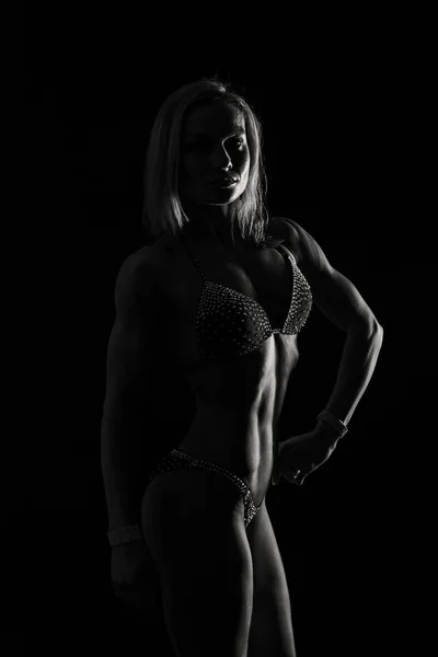 Professional fitness athlete on a black background — Stock Photo, Image
