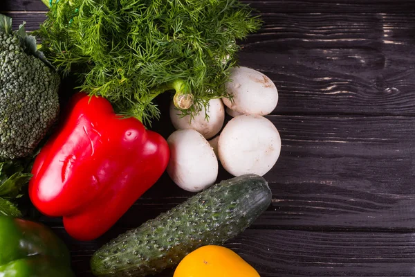 Vegetables on a black wooden background