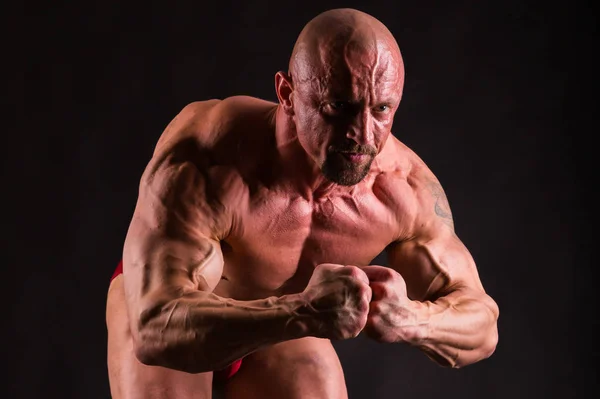 Bodybuilder posing in different poses demonstrating their muscle Royalty Free Stock Images