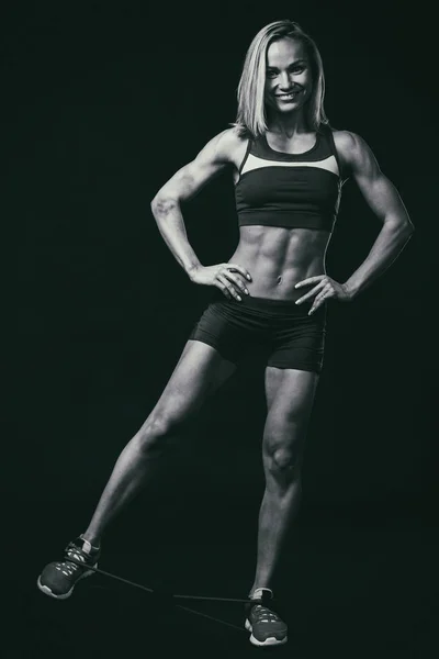 Fitness woman body on a black and white photo. — Stockfoto