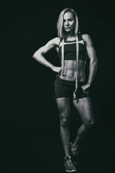 Fitness woman body on a black and white photo. — Stockfoto