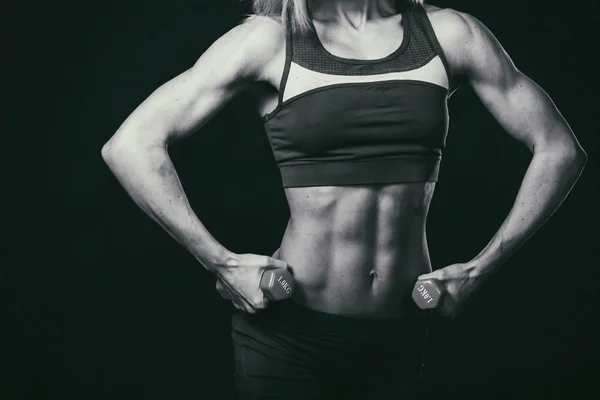 Fitness woman body on a black and white photo. — Stockfoto