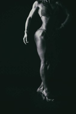 Zarif eğitim, kaslı kadın siyah bir zemin üzerine