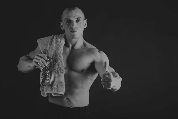 Novice bodybuilder posing on a black and white photo. — Stock Photo, Image