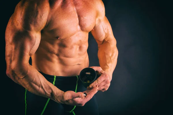 Big bodybuilder on a dark background. — Stock Photo, Image