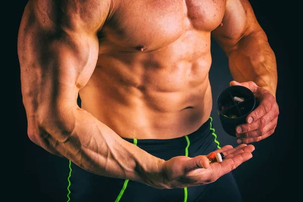 Big bodybuilder on a dark background. — Stock Photo, Image