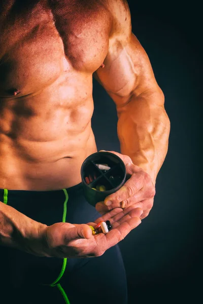 Big bodybuilder on a dark background. — Stock Photo, Image