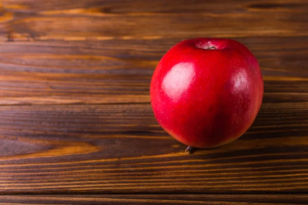 Яблоко на деревянном фоне — стоковое фото