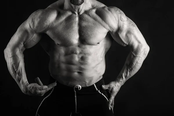 Muscular male body on a black and white photo. — Stock Photo, Image