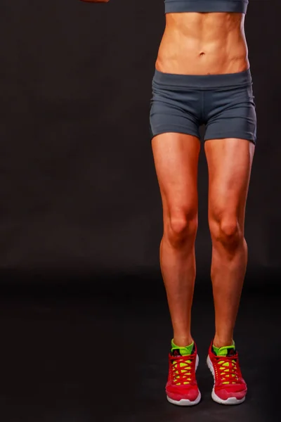 Sexy fitness woman on a dark background. — Stock Photo, Image