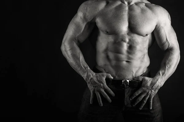 Muscular male body on a dark background. — Stock Photo, Image