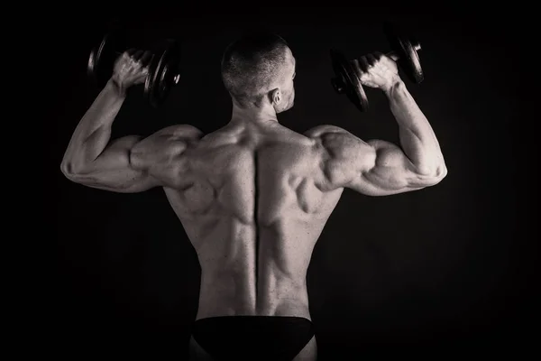 Бодібілдер показує йому спину і біцепс м'язів, особисті підкладки — стокове фото