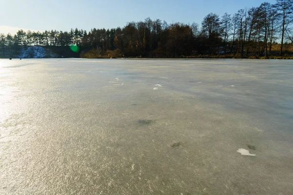 Winter fishing. Ice fishing. Fisherman on ice fishing from the w