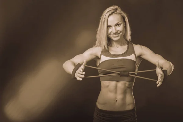 Professional fitness athlete on a dark background. — Stock Photo, Image