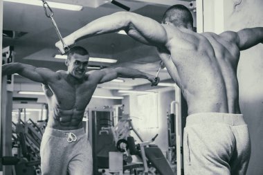 Güçlü bir adam spor salonunda devreye girer. Erkekler güç fitness.