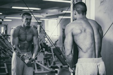 Güçlü bir adam spor salonunda devreye girer. Erkekler güç fitness.