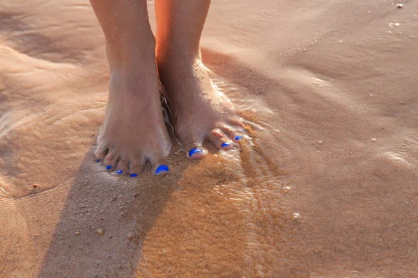 Beautiful pedicure on the sea sand — Stock Photo, Image