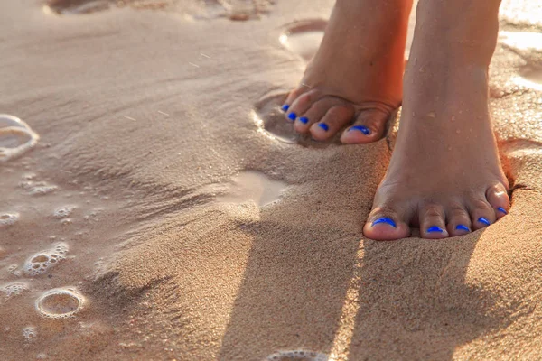 Beautiful pedicure on the sea sand — Stock Photo, Image