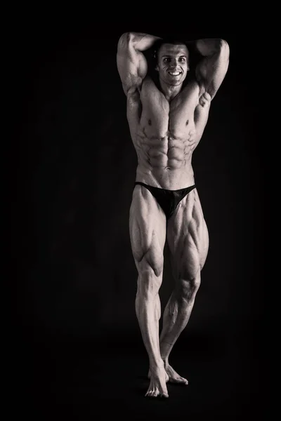 Closeup of a muscular young man  on dark background — Stock Photo, Image