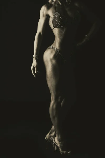 Luxe fitness meisje op een donkere achtergrond. — Stockfoto