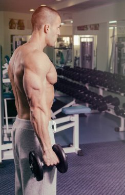 Spor salonunda dumbbells ile işgal.