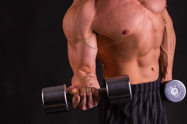 Potenza maschile fitness su uno sfondo scuro . — Foto Stock