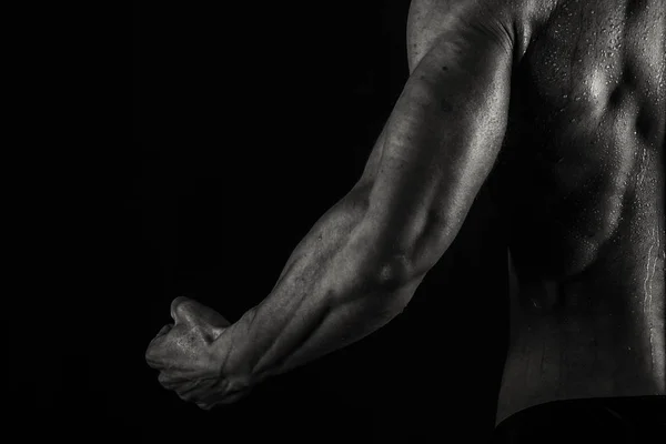 A man with a gorgeous muscular body on a black background — Stock Photo, Image