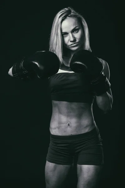 Professional fitness athlete on a dark background. — Stock Photo, Image
