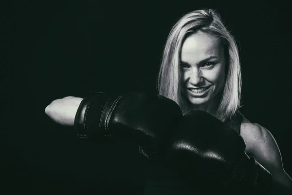 Professional fitness athlete on a dark background.