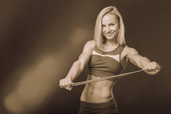 Girl with fitness equipment on a white background