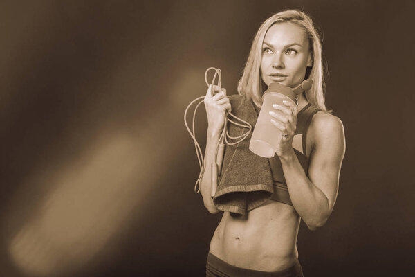 Girl with fitness equipment on a white background