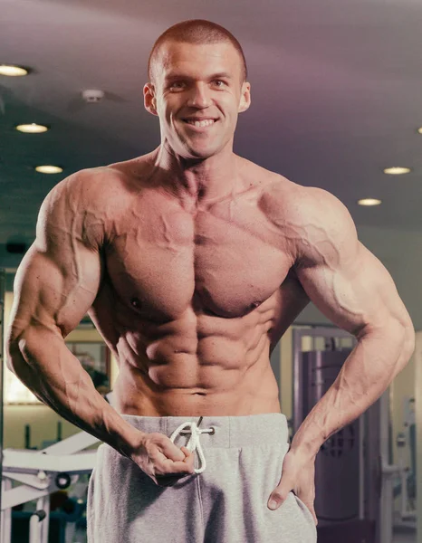 En man med en skivstång tränar biceps — Stockfoto