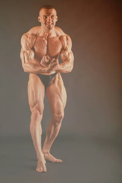 Big bodybuilder on a dark background — Stock Photo, Image