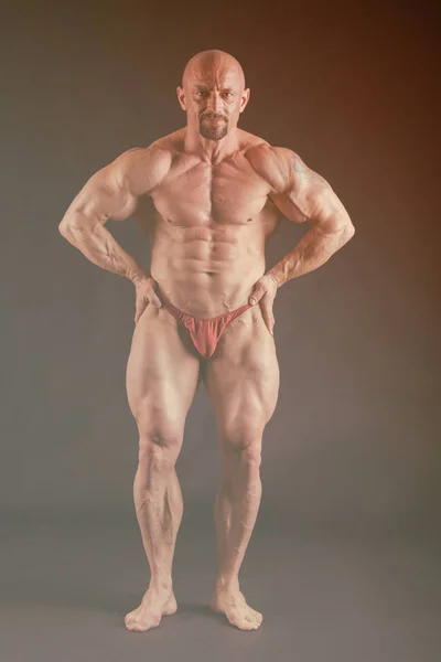 Bodybuilder auf dunklem Hintergrund. — Stockfoto