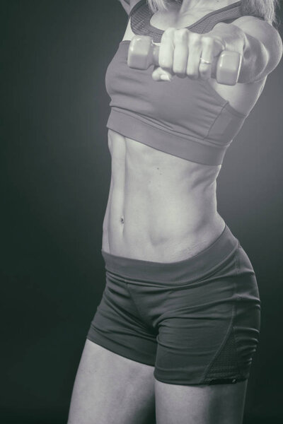 Professional fitness athlete on a black and white photo.