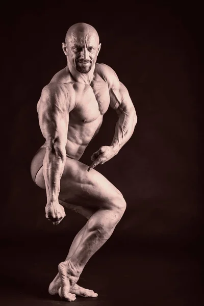 Bodybuilder on a black background. — Stock Photo, Image