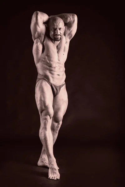 Bodybuilder on a black background. — Stock Photo, Image