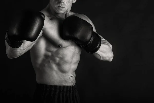 Bodybuilder op een zwarte achtergrond. — Stockfoto