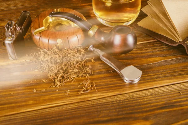 Sigara boru ve masanın üstünde defter