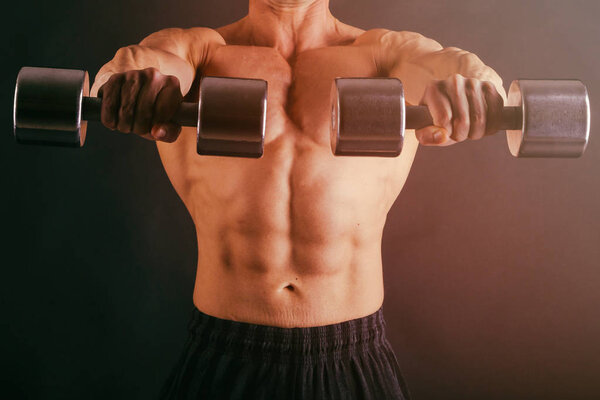 muscular male body on a dark background.